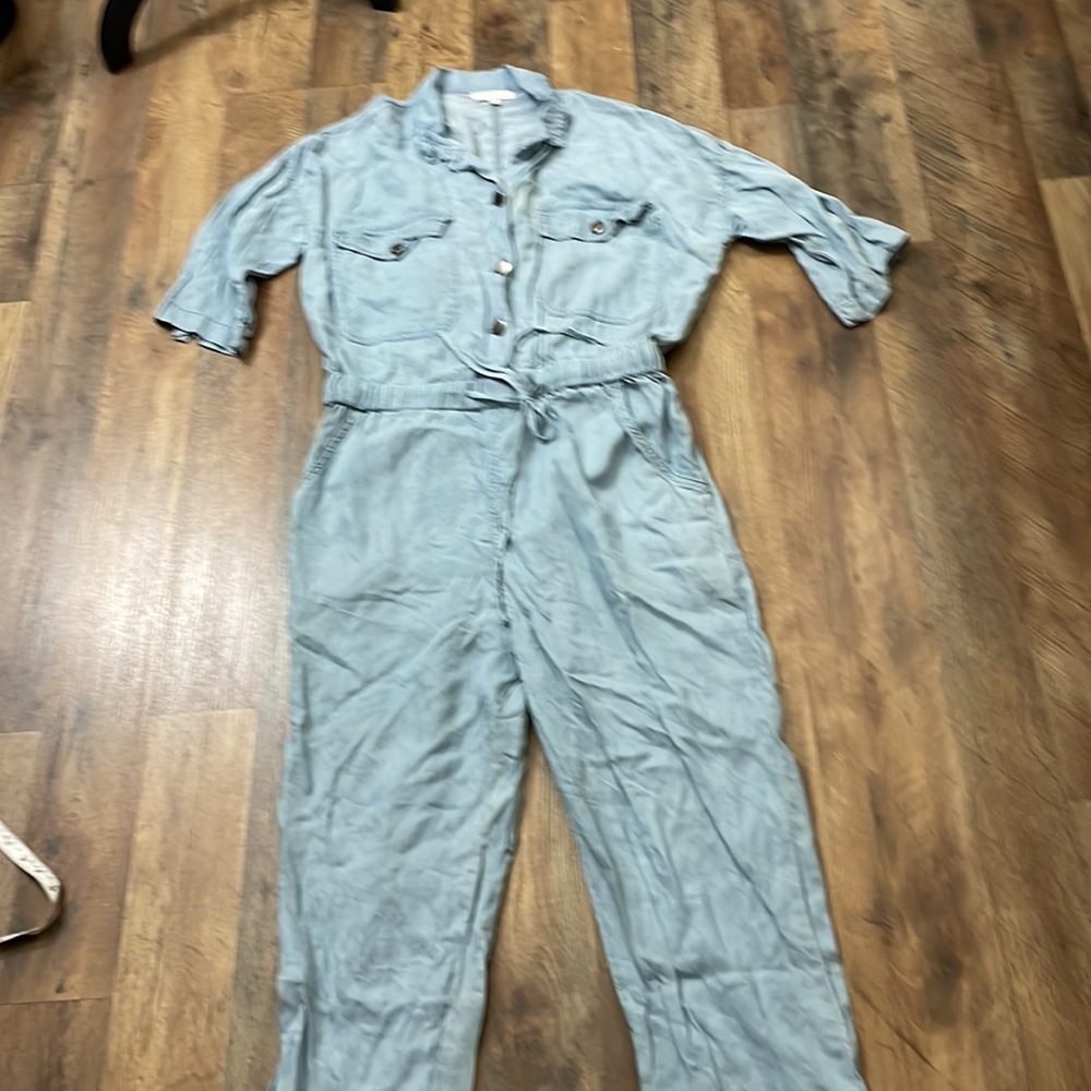 Chambray blue coverall/jumpsuit.Drawstring waist, Size L runs small.